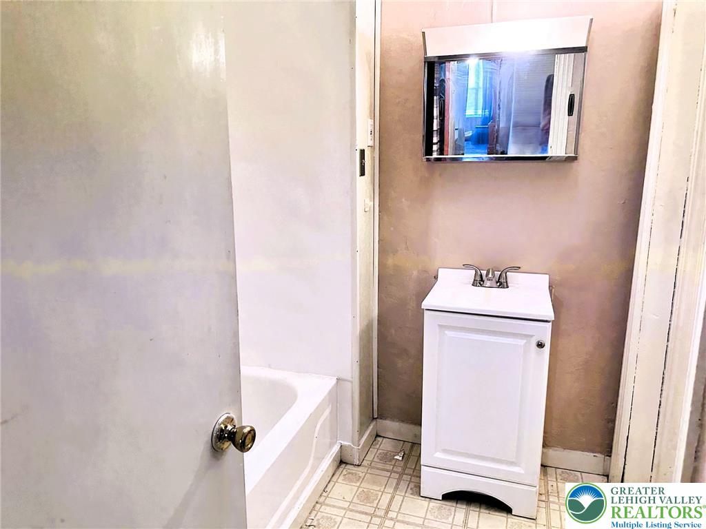 37 South 7th Street Easton, PA 18042 - Photo 8 of 23 a bathroom with a sink and a mirror
