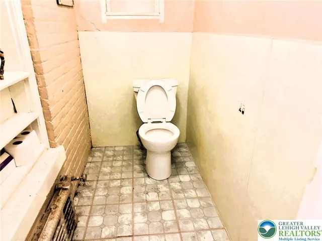 a bathroom with a toilet and a sink