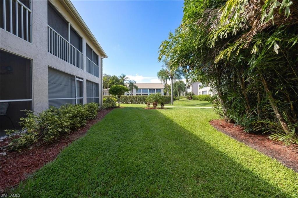 338 Bradstrom Circle, Unit 102 Naples, FL 34113 - Photo 19 of 21 a view of yard with swimming pool and green space
