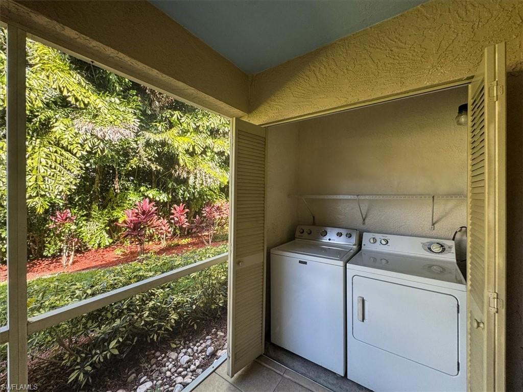 338 Bradstrom Circle, Unit 102 Naples, FL 34113 - Photo 20 of 21 a utility room with washer and dryer