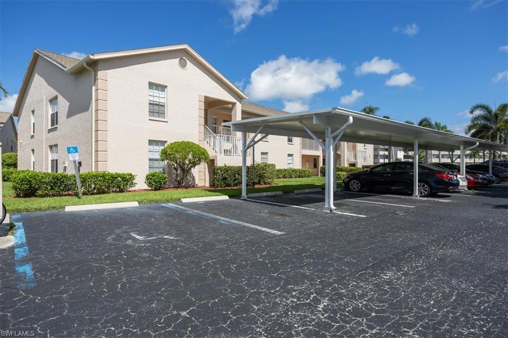 338 Bradstrom Circle, Unit 102 Naples, FL 34113 - Photo 3 of 21 a view of a white house with a yard
