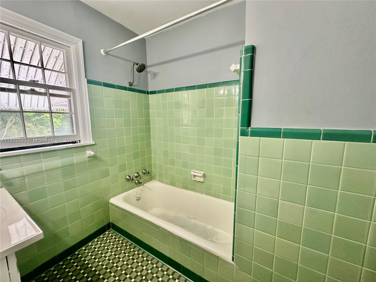 1260 Northeast 115th Street, Unit 2 Miami, FL 33161 - Photo 8 of 9 a bathroom with a shower and a bathtub