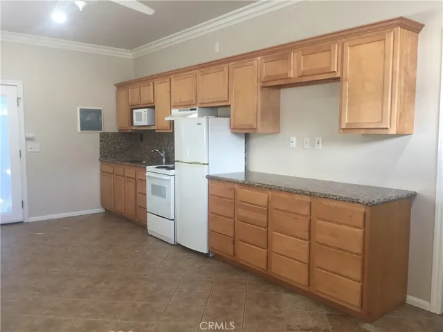 a kitchen with cabinets oven and a sink