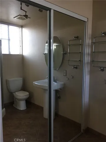 a bathroom with a toilet and a shower