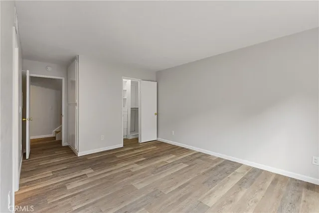 a view of an empty room and wooden floor