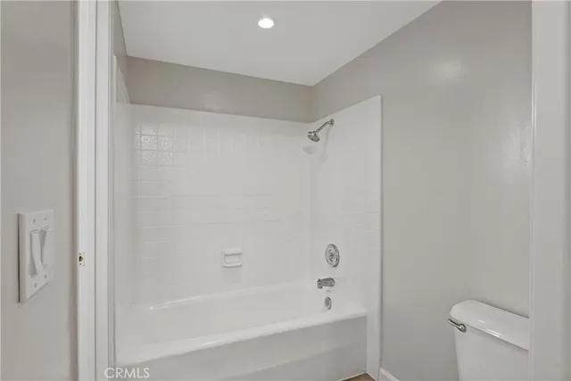 a bathroom with a bathtub and a toilet