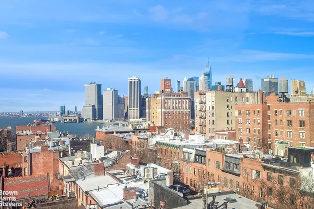 a view of a kitchen with a sink a refrigerator and a stove top oven
