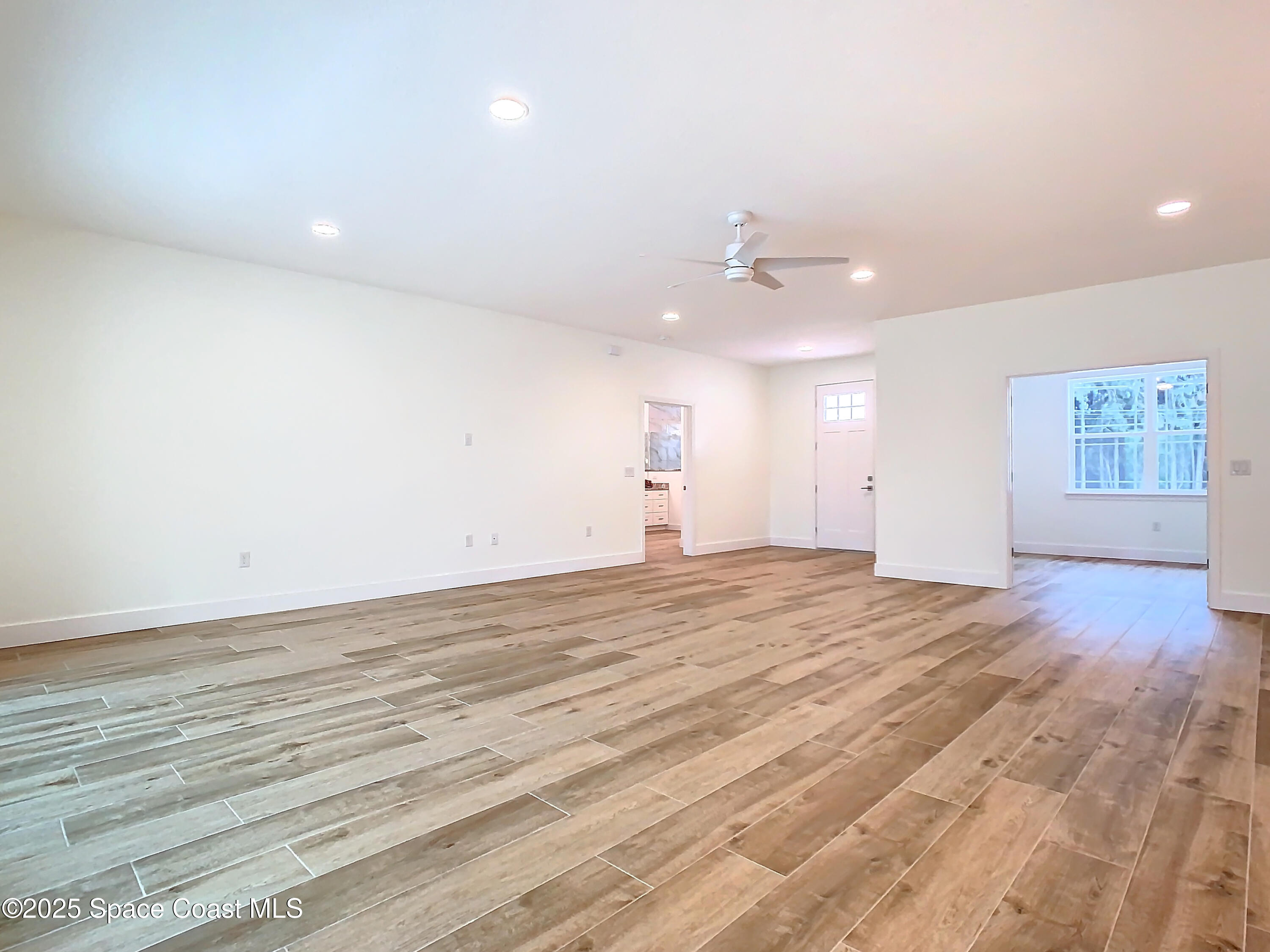 6110 Brabrook Avenue Grant, FL 32949 - Photo 13 of 85 an empty room with an entryway and wooden floor