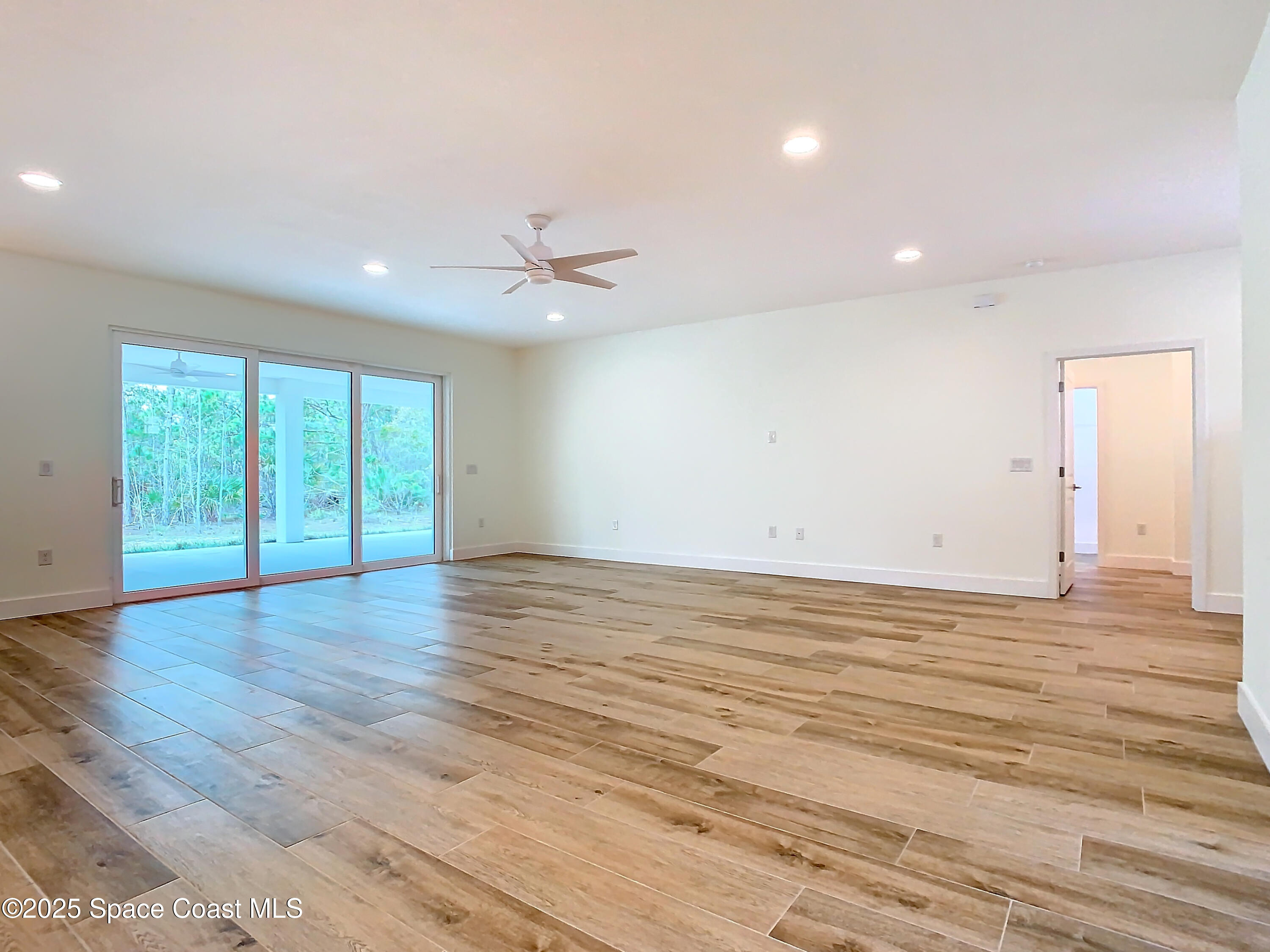 6110 Brabrook Avenue Grant, FL 32949 - Photo 14 of 85 a view of an empty room with wooden floor and a window