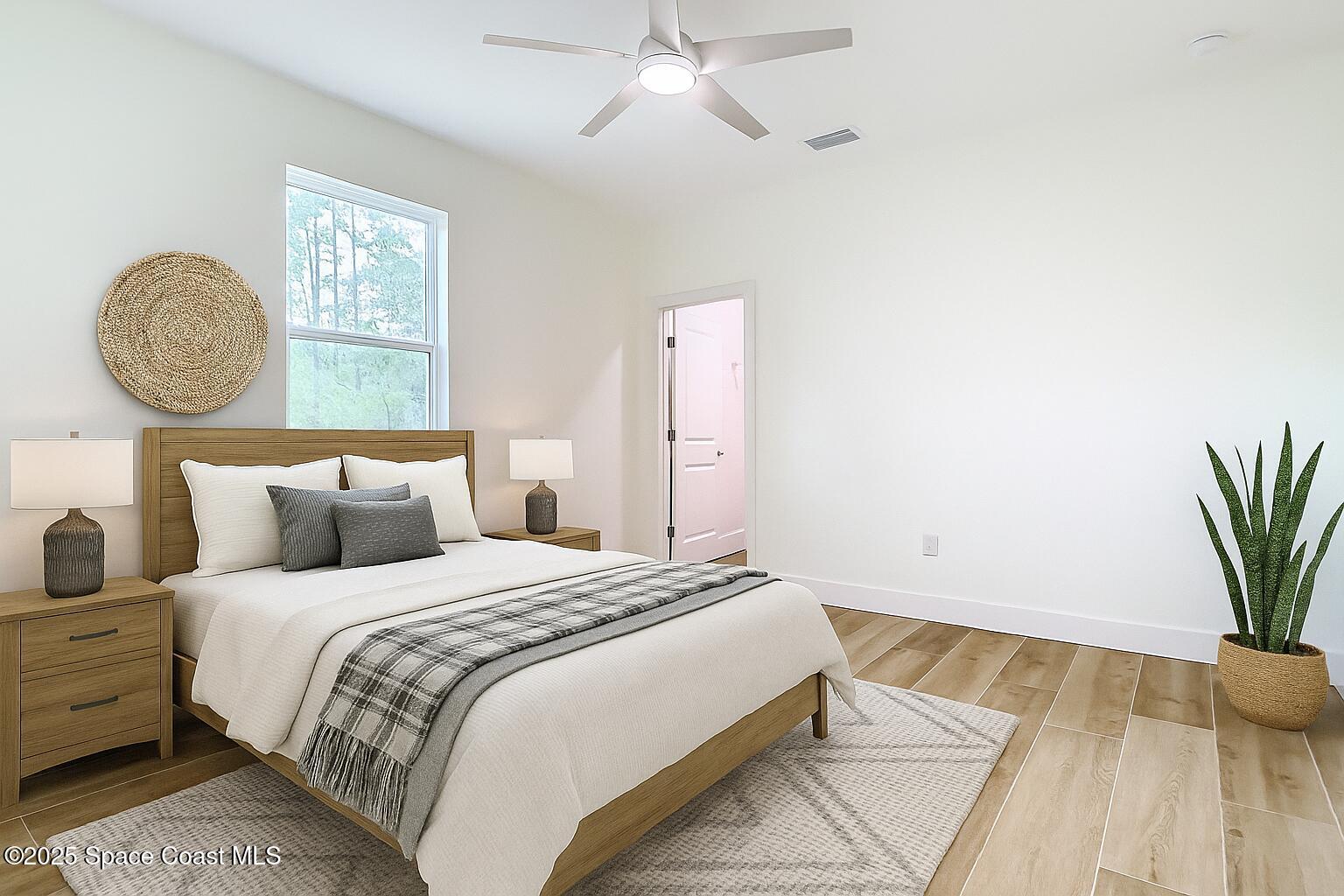 6110 Brabrook Avenue Grant, FL 32949 - Photo 33 of 85 a bedroom with a bed and a potted plant