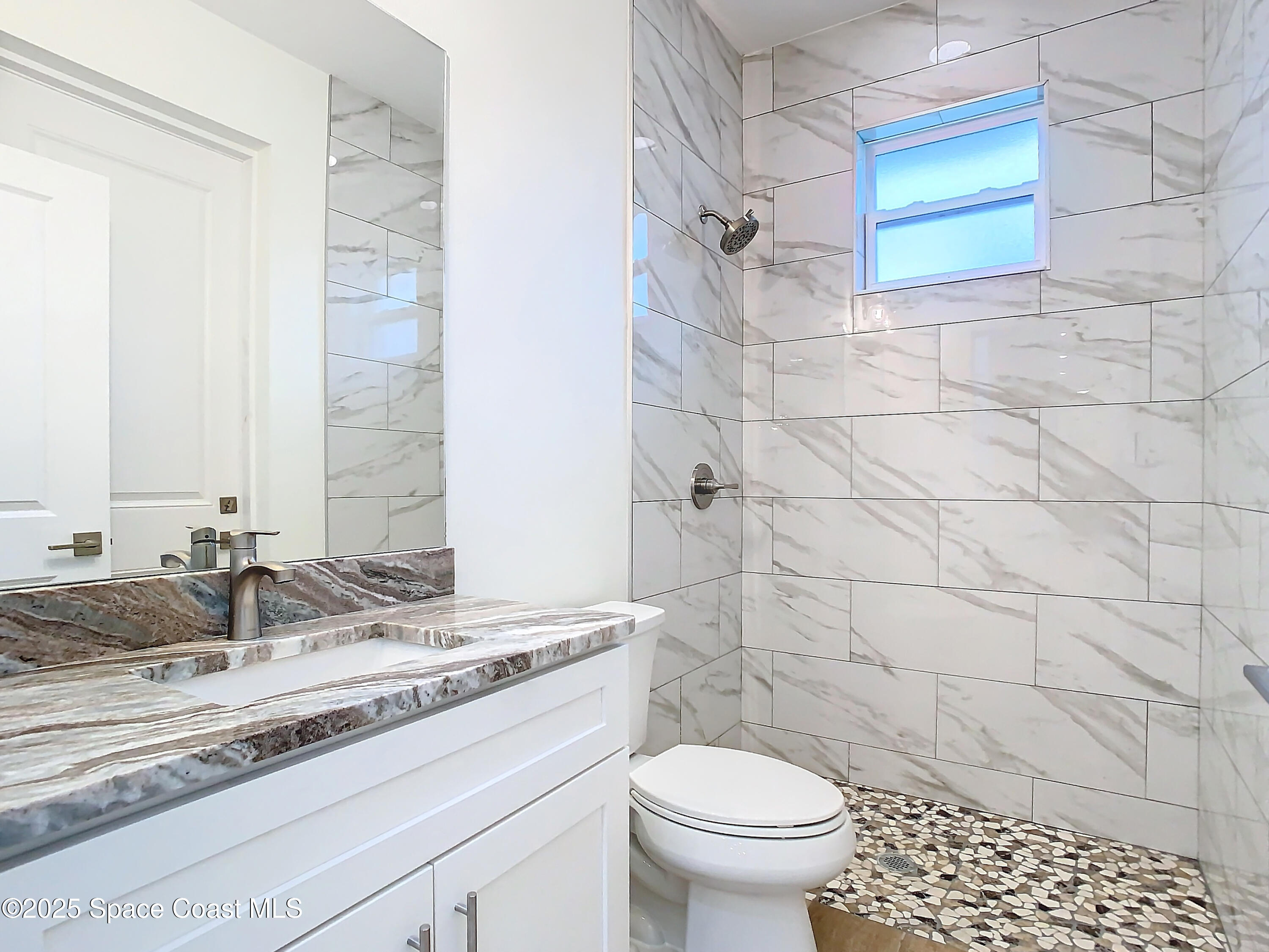 6110 Brabrook Avenue Grant, FL 32949 - Photo 35 of 85 a bathroom with a granite countertop sink a toilet and a mirror