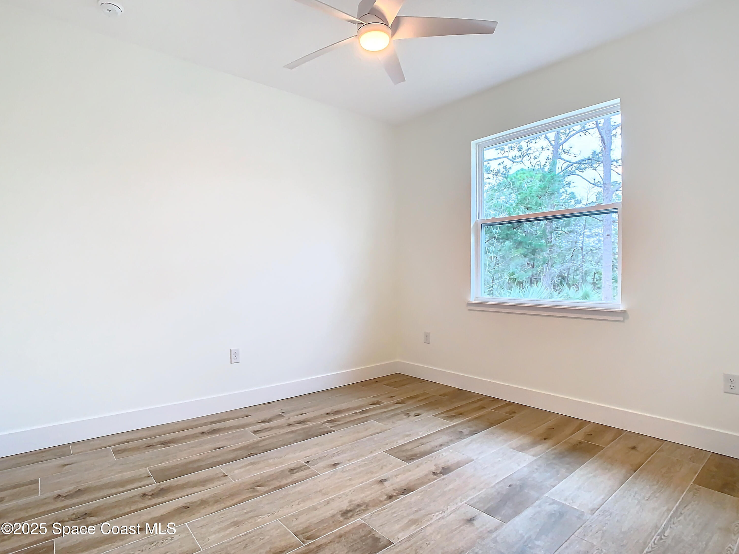 6110 Brabrook Avenue Grant, FL 32949 - Photo 40 of 85 an empty room with wooden floor and windows