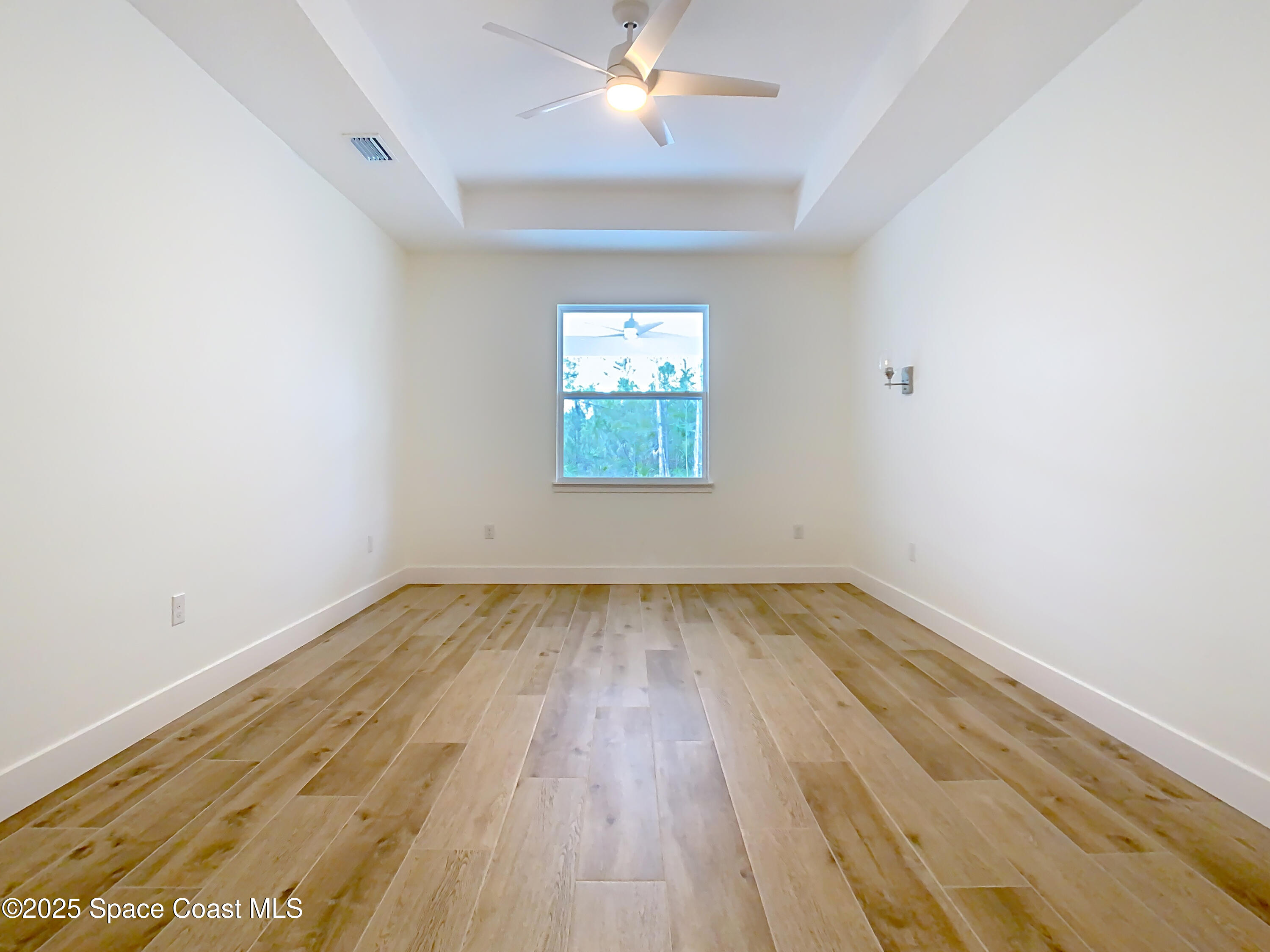 6110 Brabrook Avenue Grant, FL 32949 - Photo 44 of 85 an empty room with wooden floor and windows