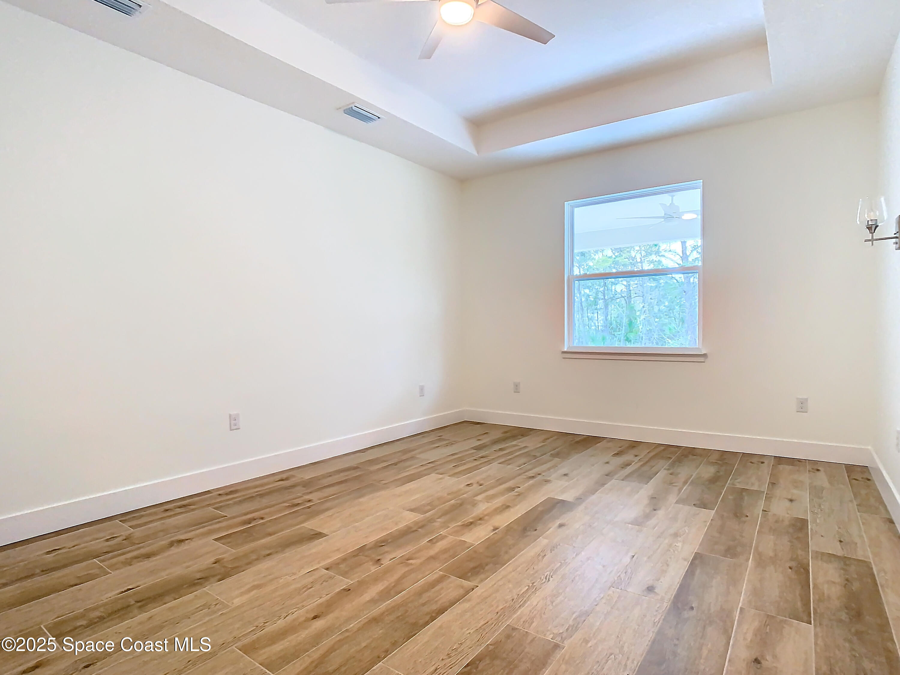6110 Brabrook Avenue Grant, FL 32949 - Photo 45 of 85 an empty room with wooden floor and windows
