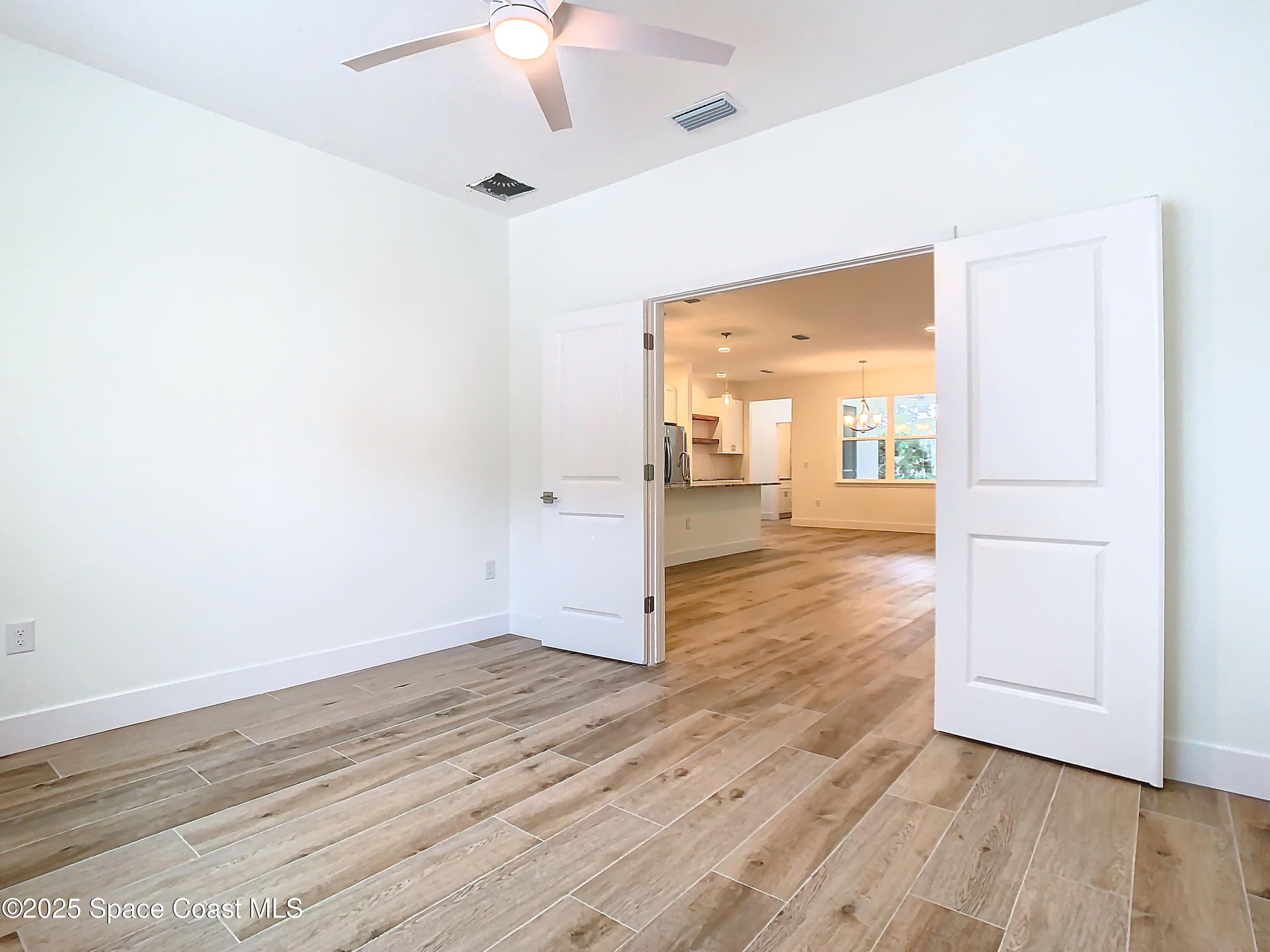 6110 Brabrook Avenue Grant, FL 32949 - Photo 46 of 85 wooden floor in an empty room with a window