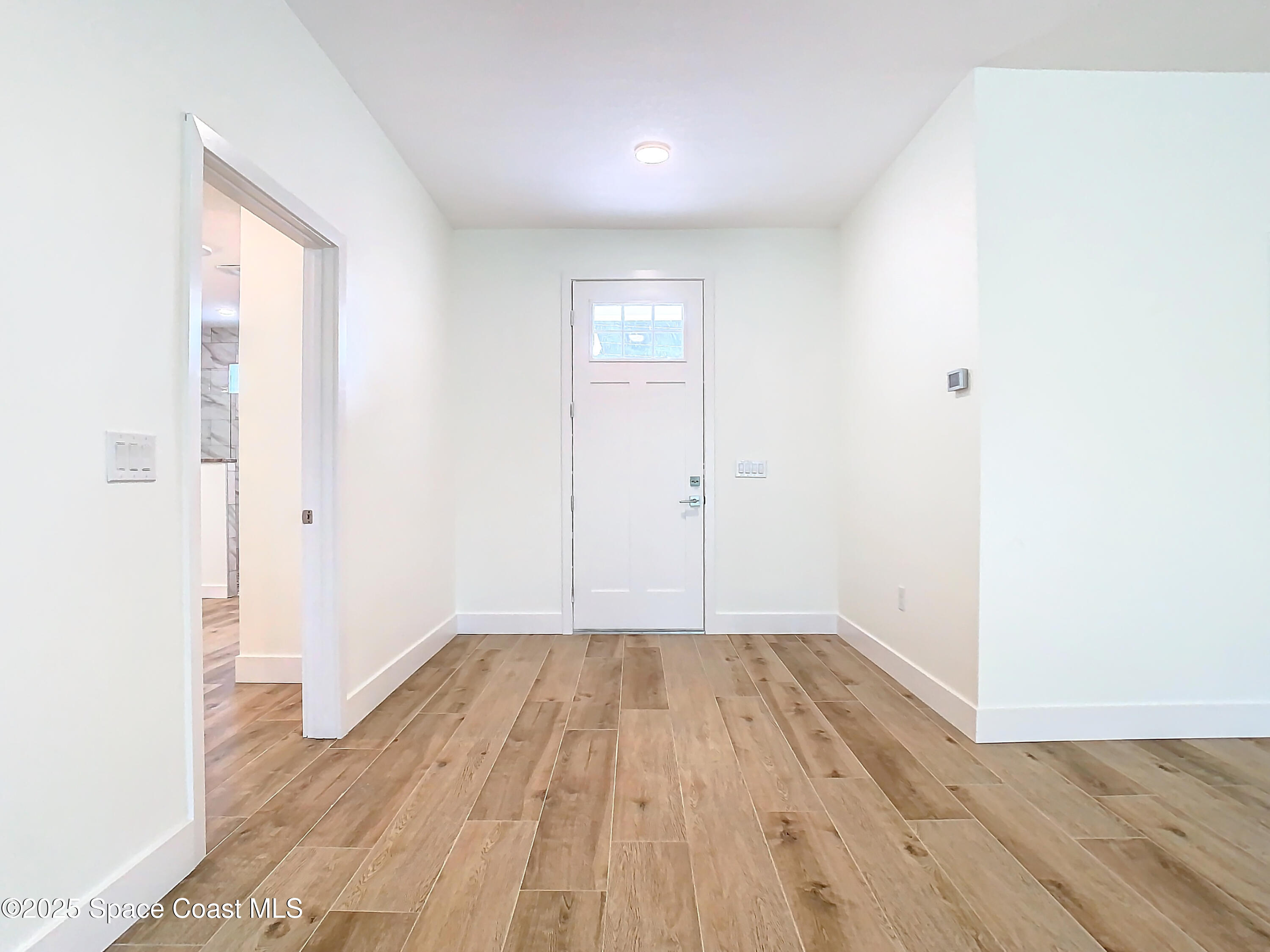 6110 Brabrook Avenue Grant, FL 32949 - Photo 5 of 85 a view of a room with wooden floor and white walls