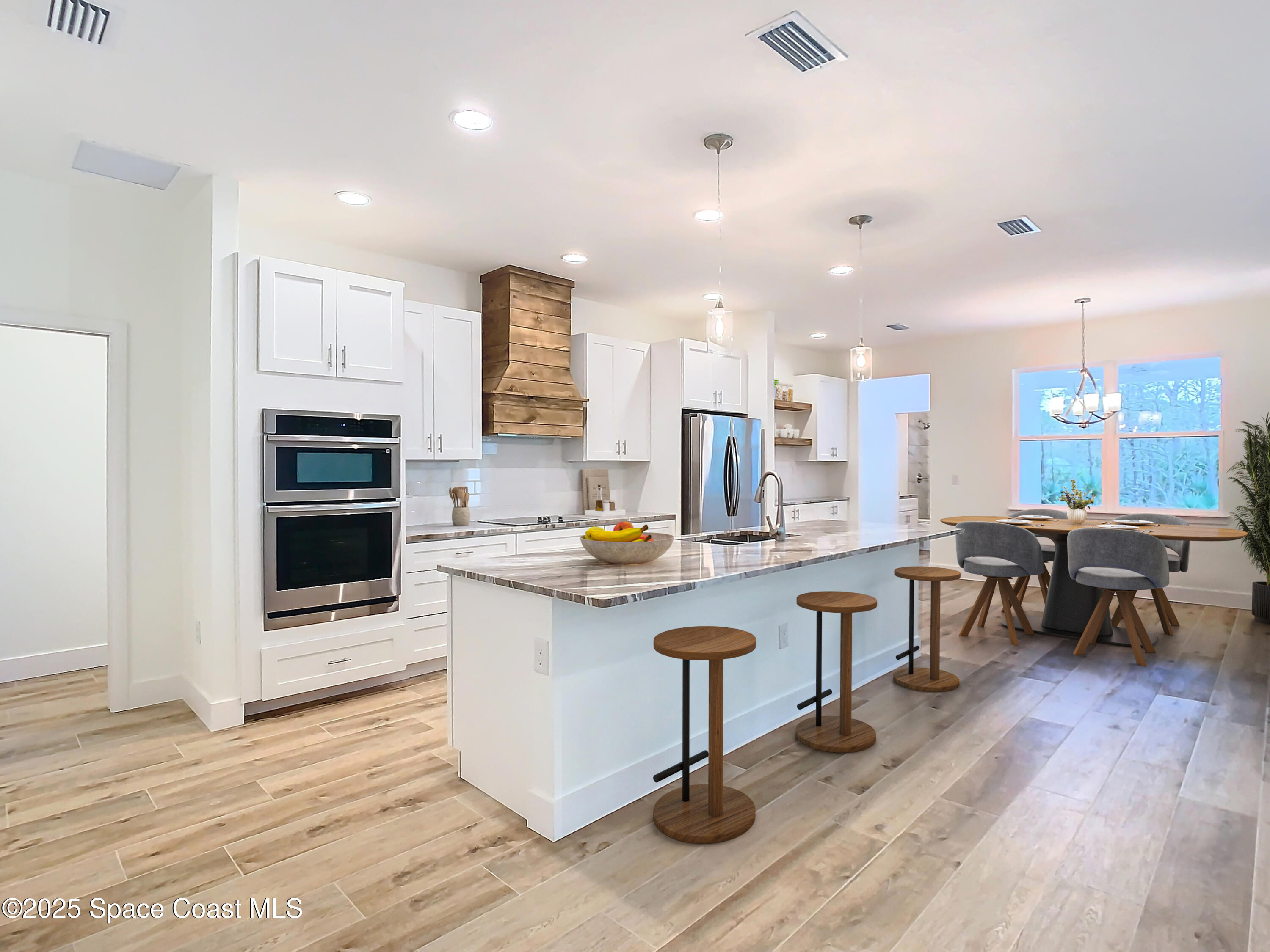 6110 Brabrook Avenue Grant, FL 32949 - Photo 7 of 85 a kitchen with stainless steel appliances granite countertop a stove top oven a sink dishwasher a dining table and chairs with wooden floor