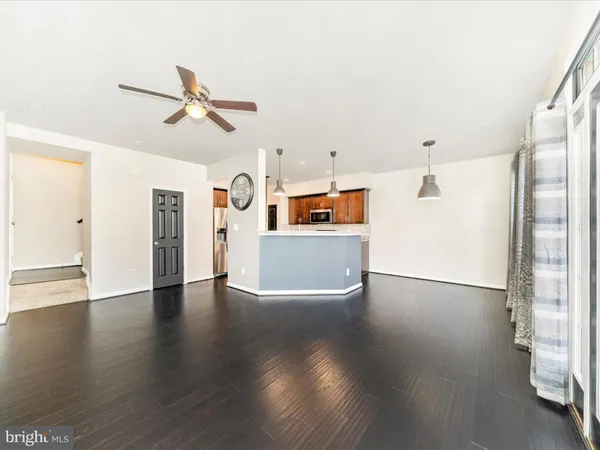 a view of a kitchen with furniture and wooden floor