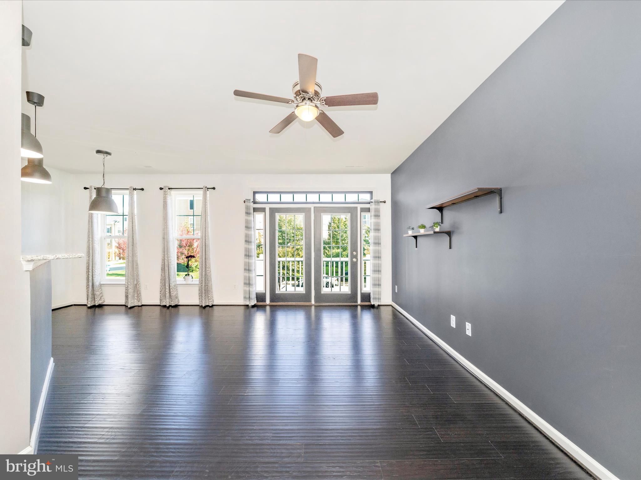 5880 Imperial Drive Frederick, MD 21703 - Photo 14 of 54 a view of an empty room with wooden floor and a window