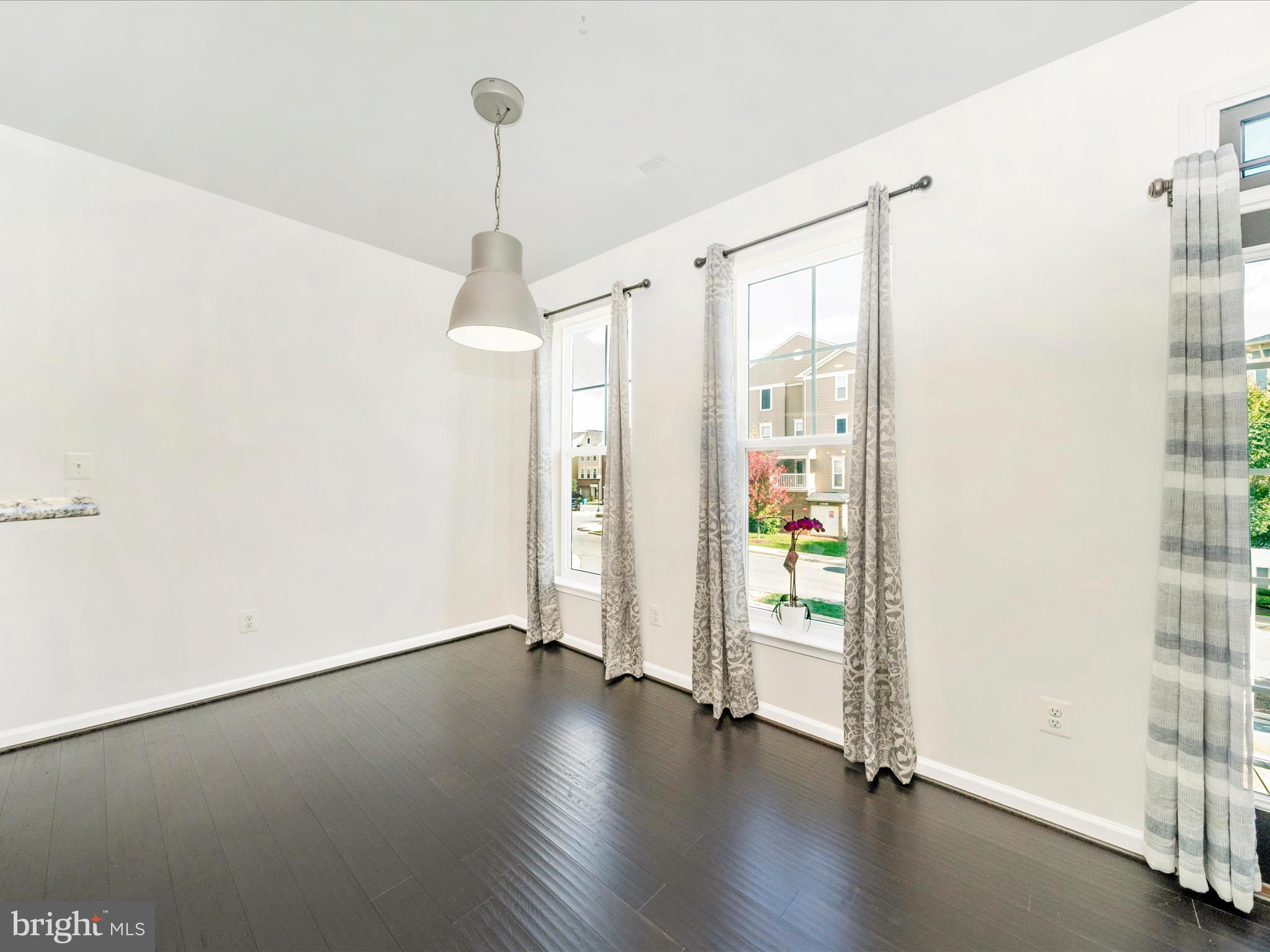 5880 Imperial Drive Frederick, MD 21703 - Photo 15 of 54 a view of an empty room with window and wooden floor
