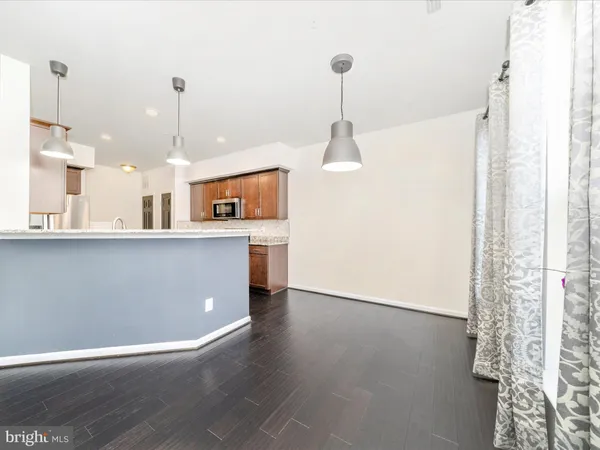 a view of a kitchen with furniture and wooden floor