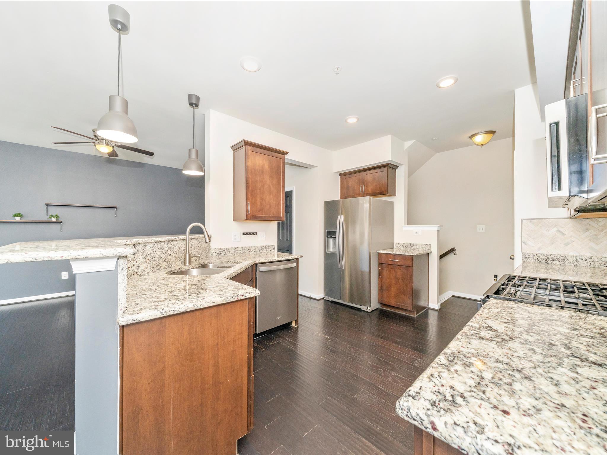 5880 Imperial Drive Frederick, MD 21703 - Photo 23 of 54 a kitchen with stainless steel appliances granite countertop a sink dishwasher and a stove with wooden floor