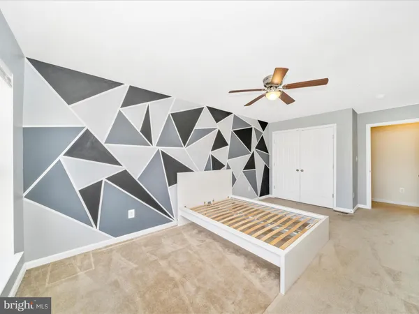 a bathroom with a sink a toilet a mirror and shower