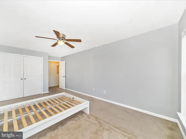 a spacious bedroom with a bed and a flat screen tv