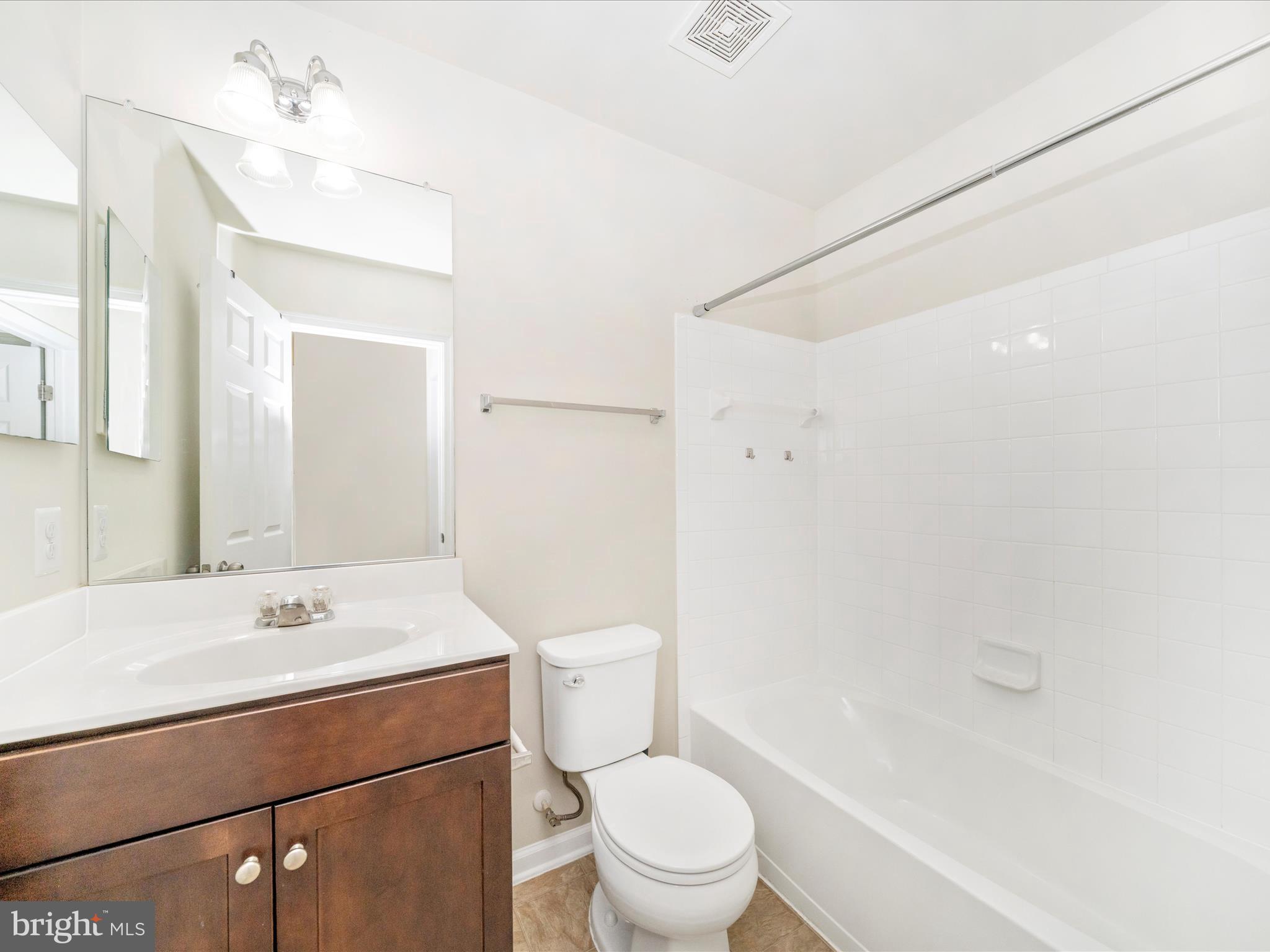 5880 Imperial Drive Frederick, MD 21703 - Photo 38 of 54 a bathroom with a sink a toilet a mirror and shower