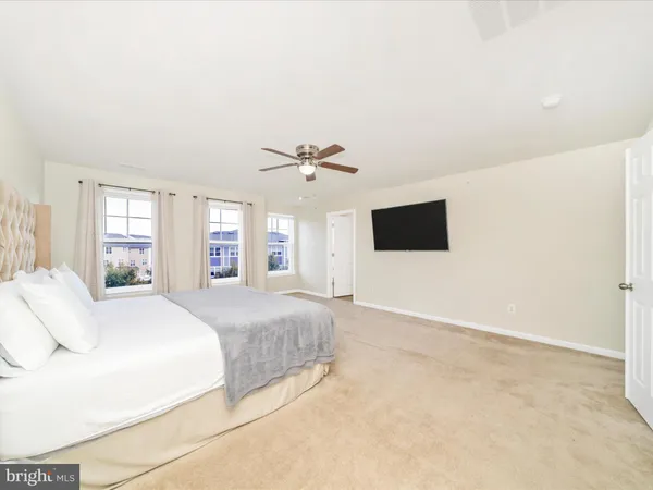 a spacious bedroom with a bed and a cabinets