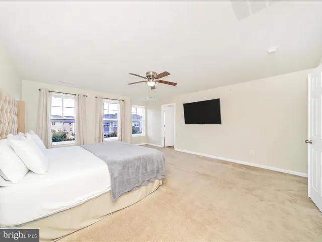 a spacious bedroom with a bed and a cabinets