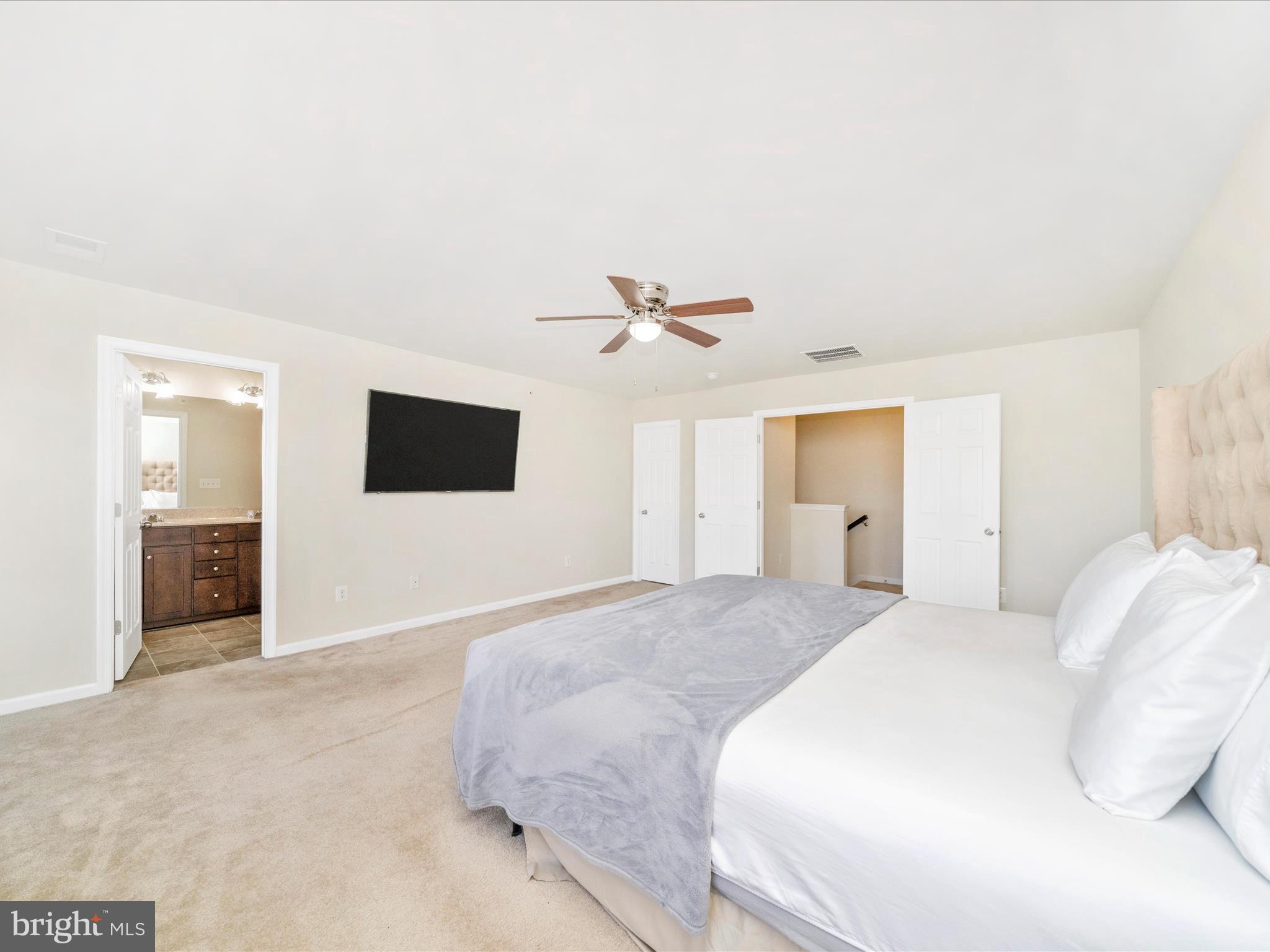 5880 Imperial Drive Frederick, MD 21703 - Photo 41 of 54 a spacious bedroom with a bed and a flat screen tv