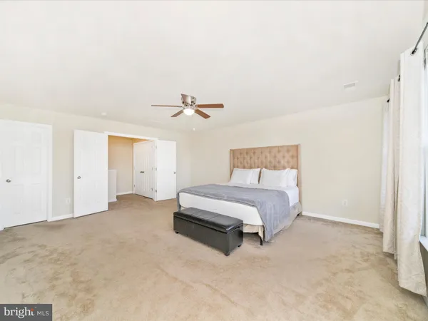 a spacious bathroom with a granite countertop tub sink shower and mirror