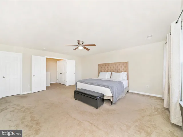 a spacious bathroom with a granite countertop tub sink shower and mirror