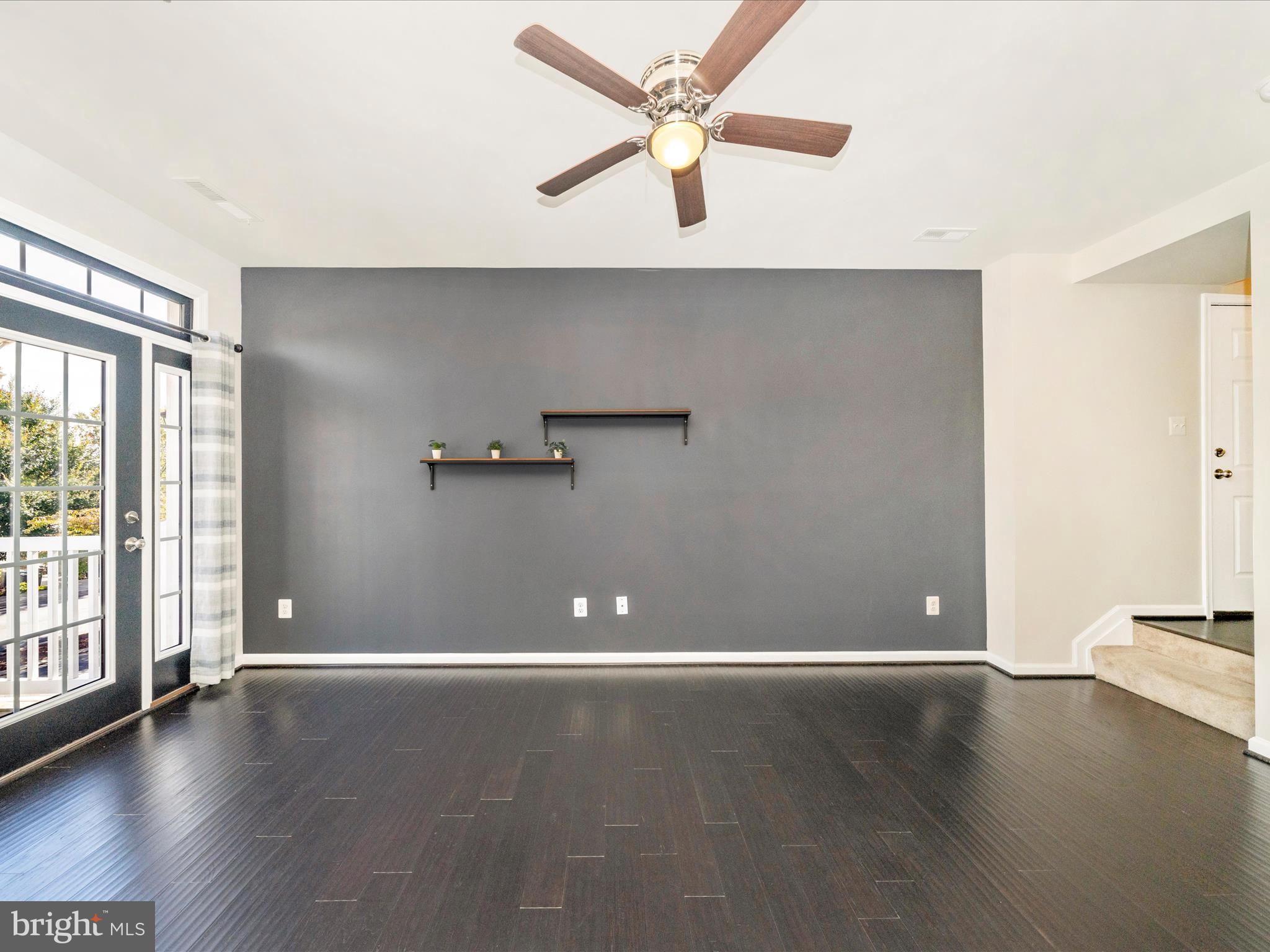 5880 Imperial Drive Frederick, MD 21703 - Photo 50 of 54 an empty room with wooden floor and windows with curtains