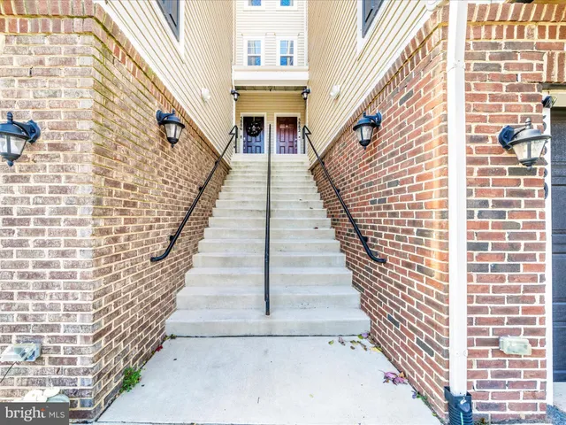 a view of stairs with wooden floor and windows