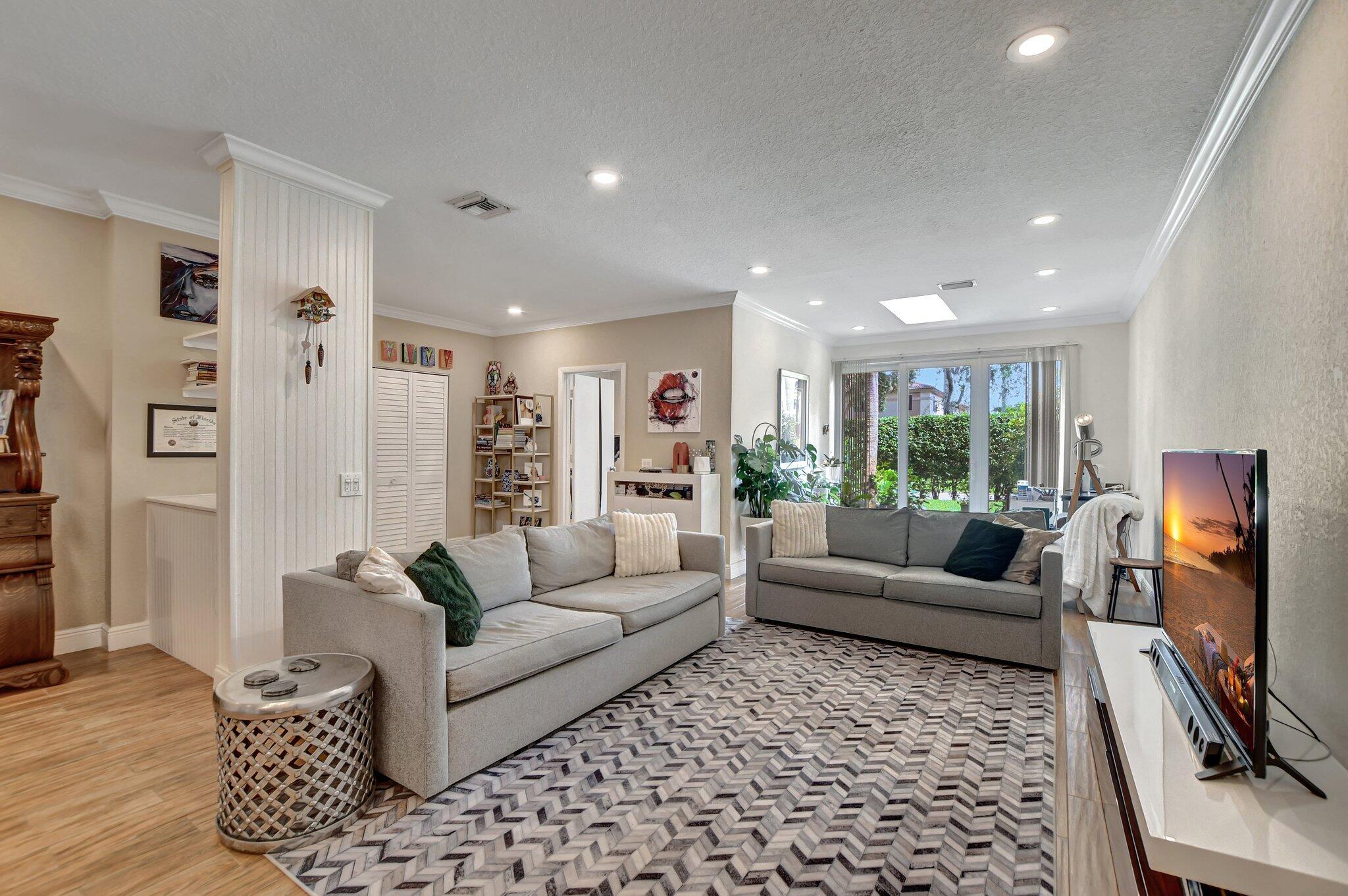 6682 Via Regina Boca Raton, FL 33433 - Photo 2 of 46 a living room with furniture and a flat screen tv
