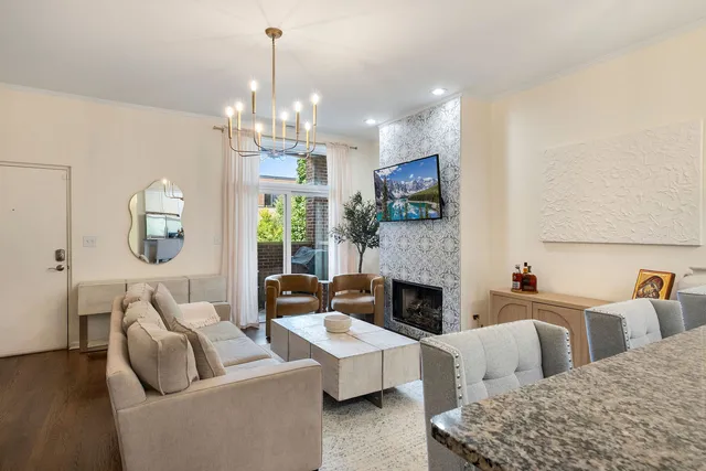 a living room with fireplace furniture and a chandelier