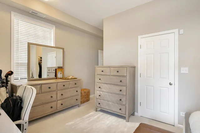 a room with a dresser and a mirror