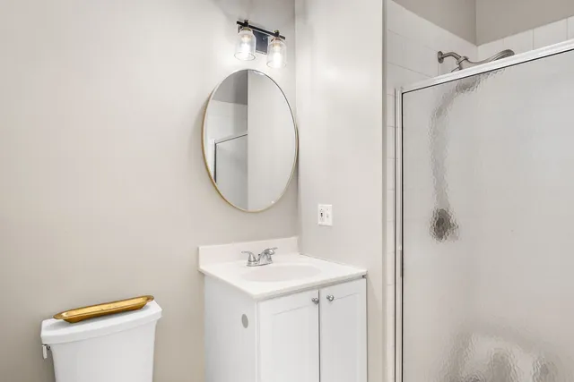 a bathroom with a sink a toilet and a mirror