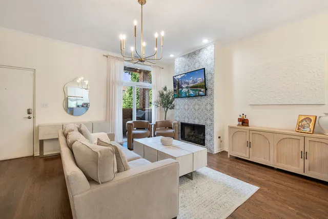 a living room with furniture fireplace and a chandelier