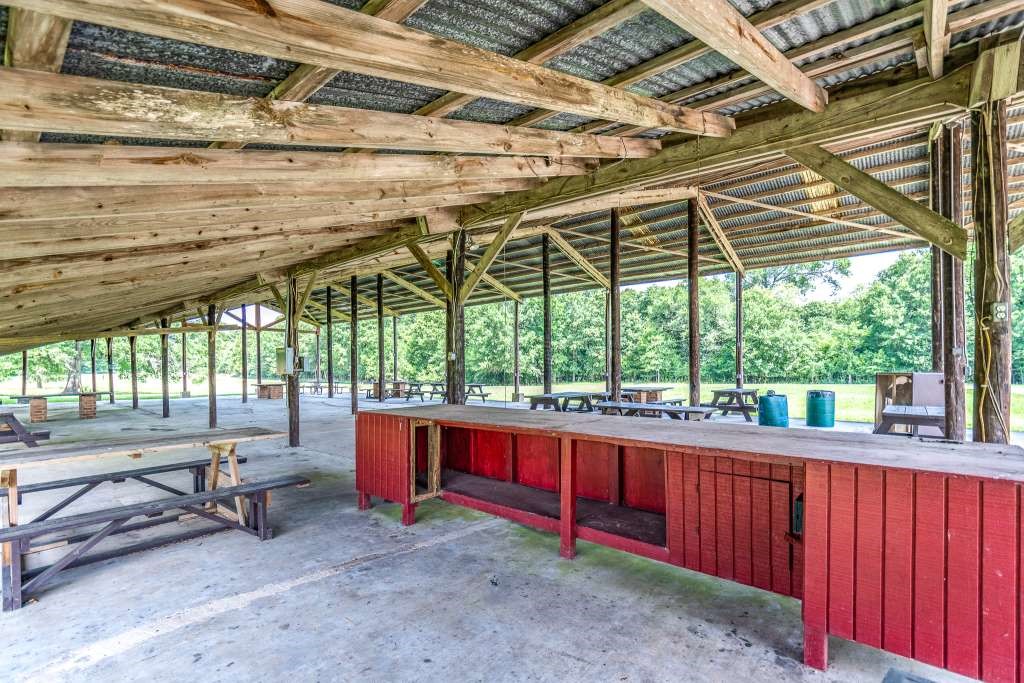 129 Shoreline Drive Cleveland, TX 77327 - Photo 18 of 22 a room with large trees and outdoor seating