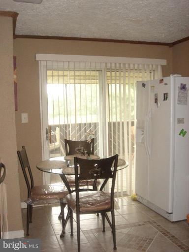 4018 Winlee Road Randallstown, MD 21133 - Photo 3 of 5 a view of a dining room with furniture window and outside view