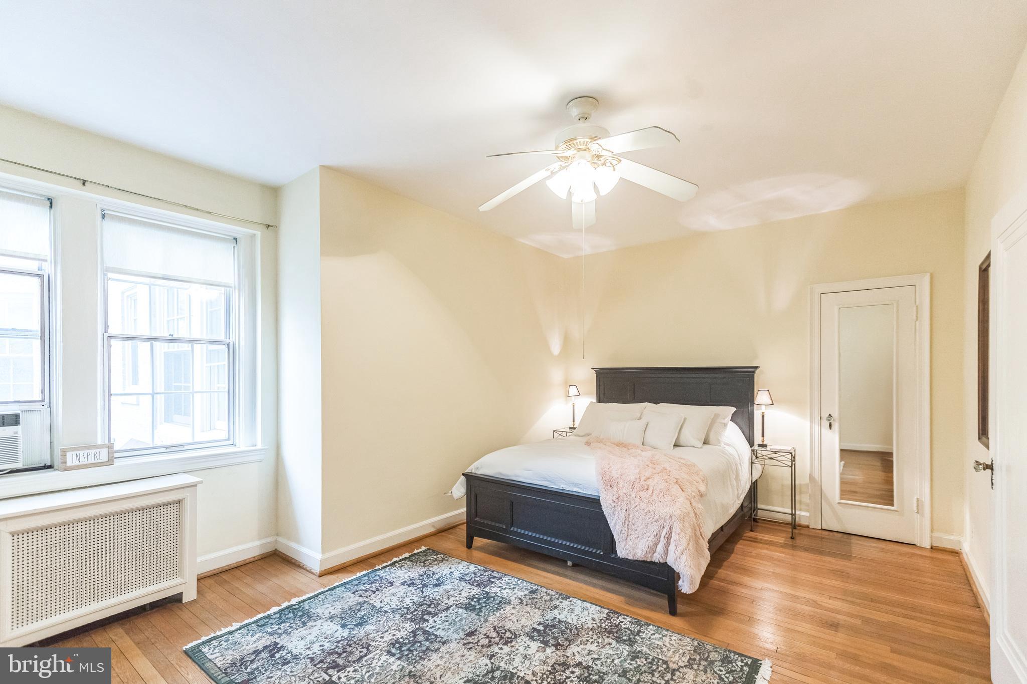 2737 Devonshire Place Northwest, Unit 7 Washington, DC 20008 - Photo 24 of 36 a bedroom with a bed and wooden floor