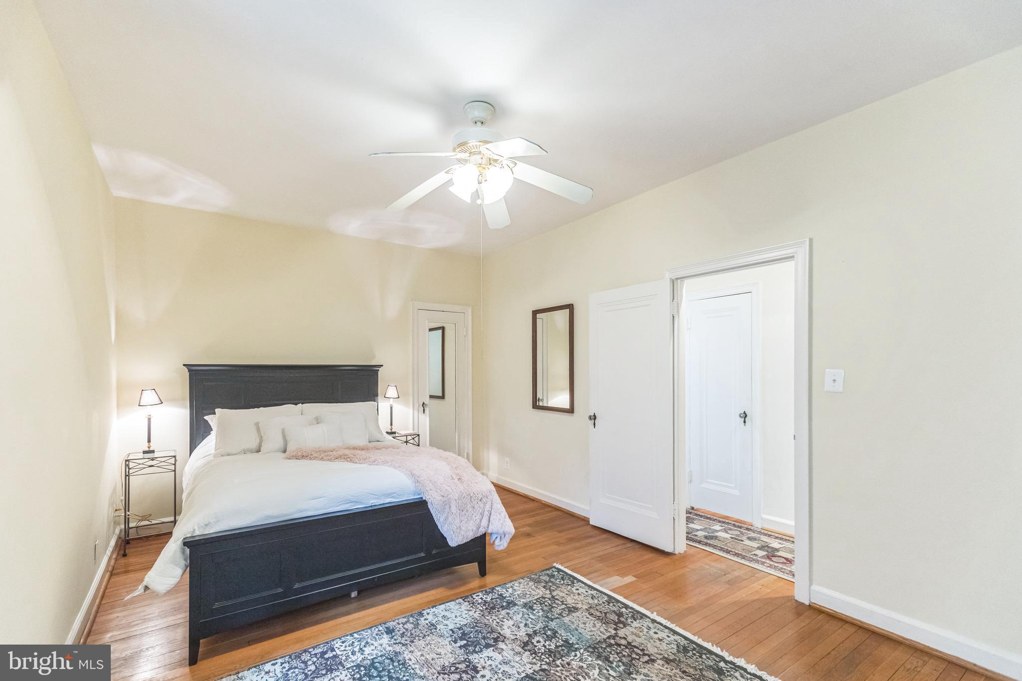 2737 Devonshire Place Northwest, Unit 7 Washington, DC 20008 - Photo 25 of 36 a bedroom with a bed and a chandelier
