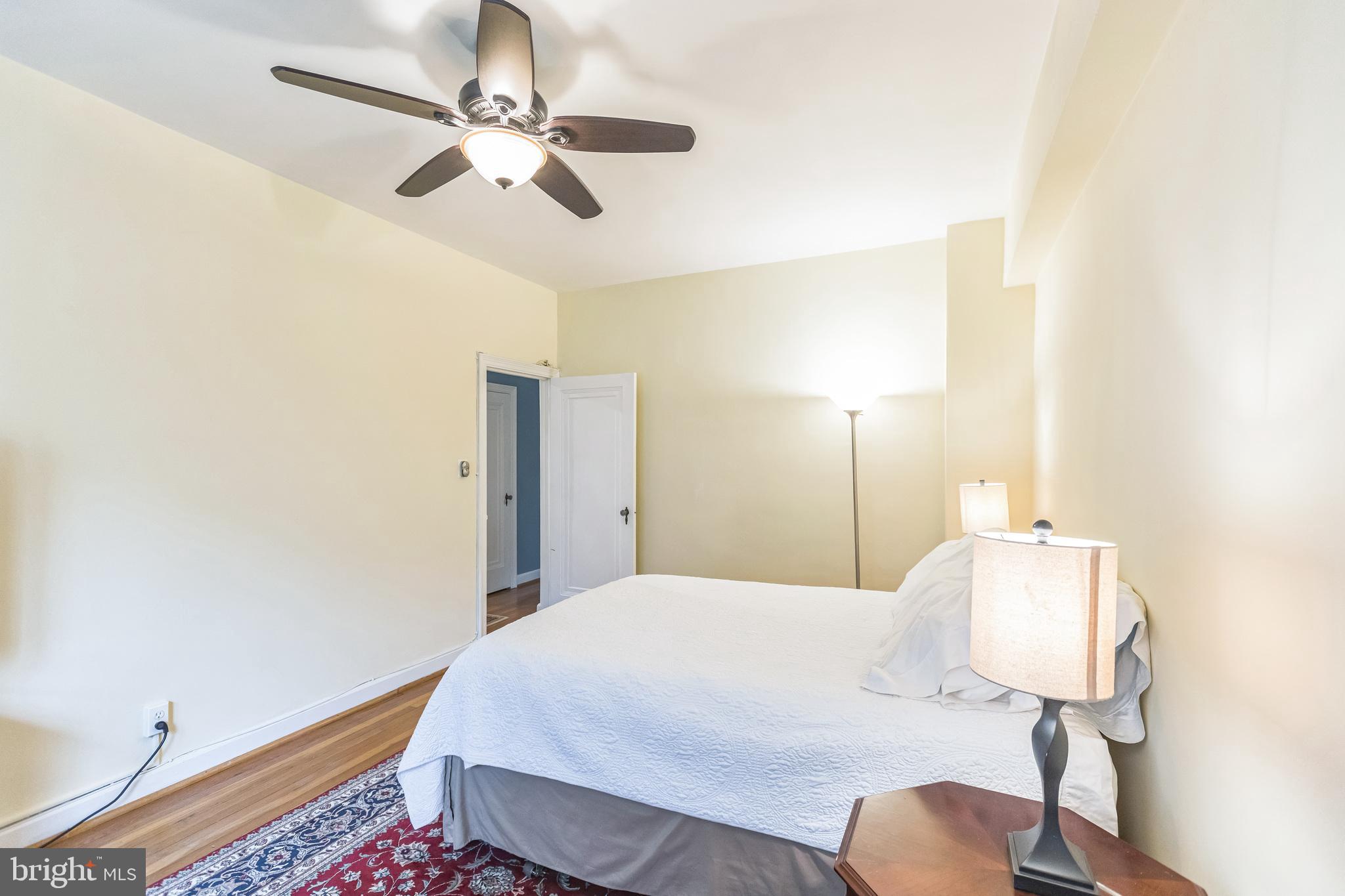 2737 Devonshire Place Northwest, Unit 7 Washington, DC 20008 - Photo 29 of 36 a bedroom with a bed and a chandelier