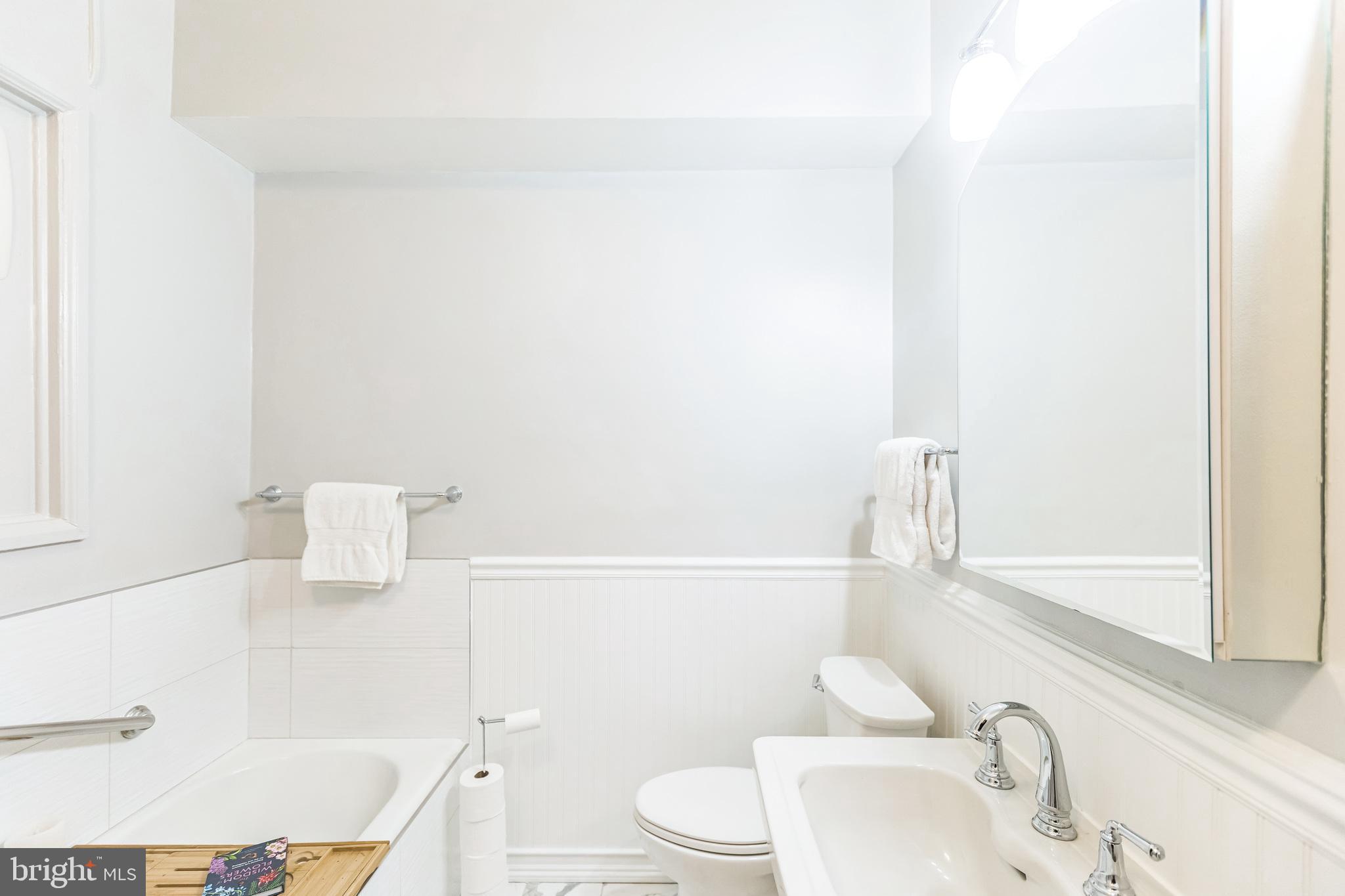 2737 Devonshire Place Northwest, Unit 7 Washington, DC 20008 - Photo 32 of 36 a bathroom with a sink a toilet and tub