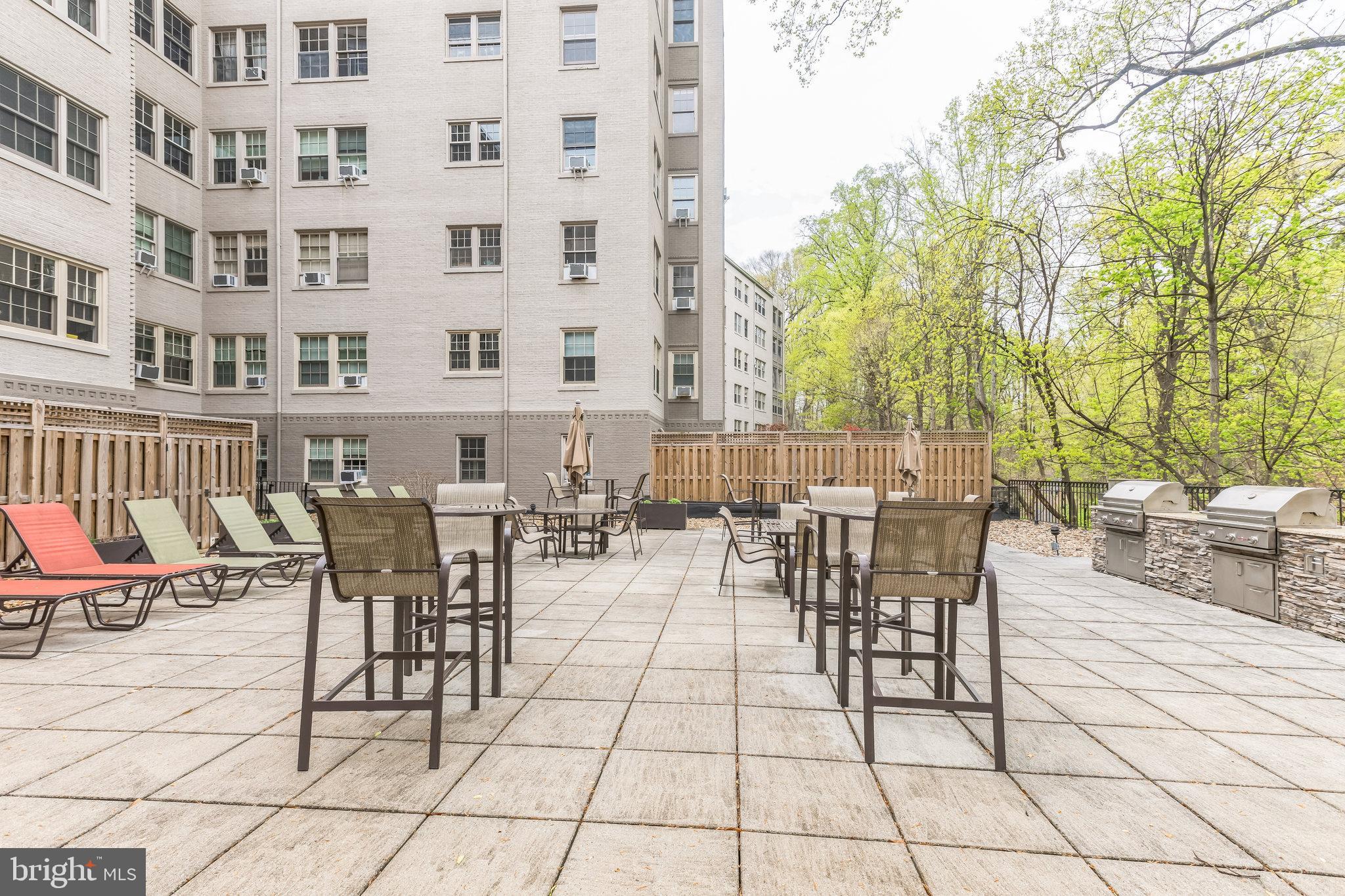 2737 Devonshire Place Northwest, Unit 7 Washington, DC 20008 - Photo 34 of 36 a view of a patio with dining table and chairs with wooden floor and fence
