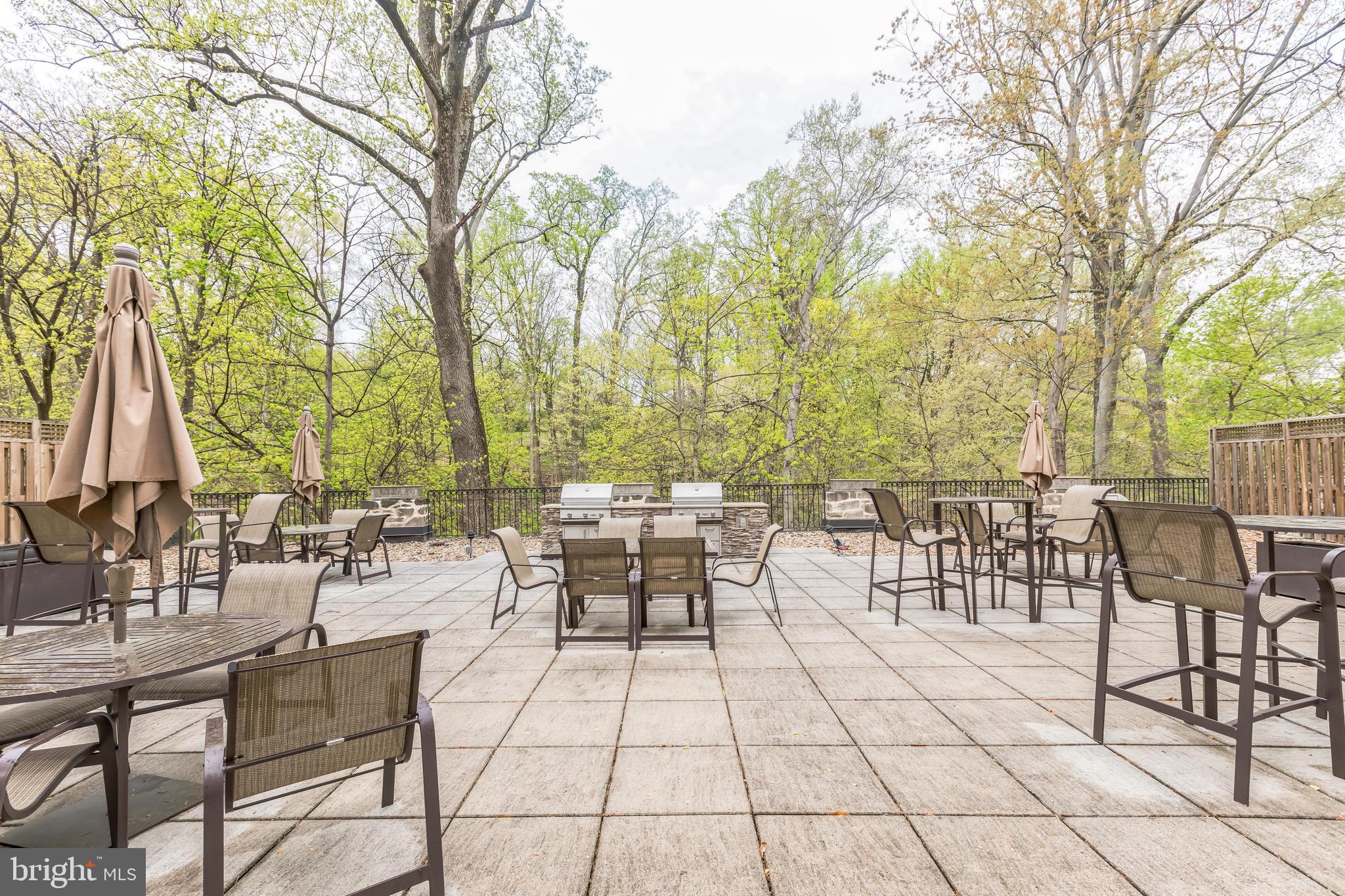 2737 Devonshire Place Northwest, Unit 7 Washington, DC 20008 - Photo 35 of 36 a view of a patio with dining table and chairs with wooden floor and fence