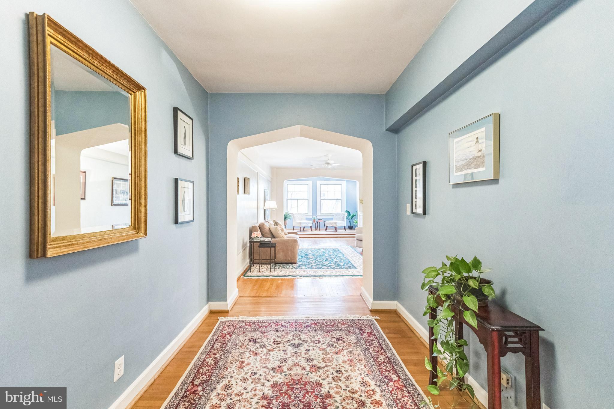 2737 Devonshire Place Northwest, Unit 7 Washington, DC 20008 - Photo 5 of 36 a hallway with a flower pot and table